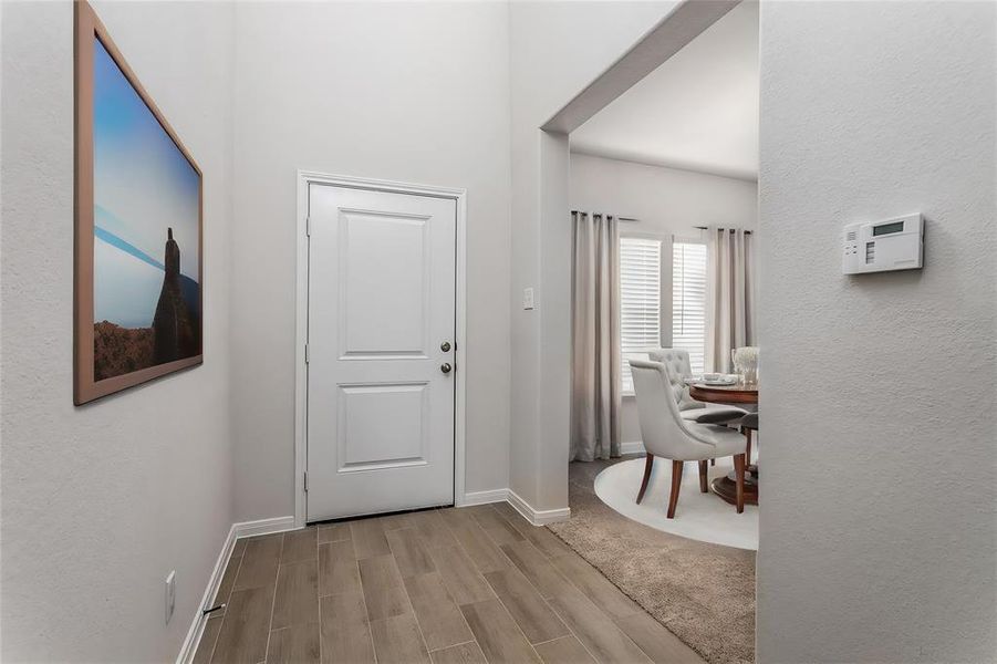 Step into the welcoming entryway of this beautiful new home in Glendale Lakes. The bright and airy foyer sets the tone with its high ceilings and natural light. The elegant tile flooring provides a seamless flow throughout the main living areas. Perfect for greeting guests, the entryway offers a glimpse into the open and inviting layout of this charming residence. Photos are from another Rylan floor plan.