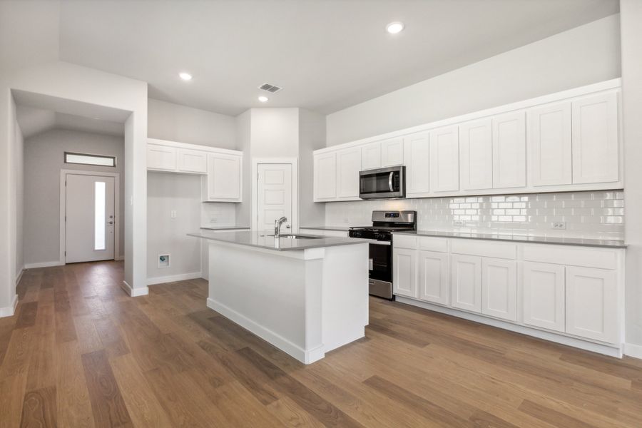 Kitchen in the Cedar home plan by Trophy Signature Homes – REPRESENTATIVE PHOTO