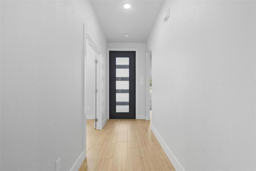 Doorway with wood finished floors and recessed lighting Doorway with wood finished floors and recessed lighting