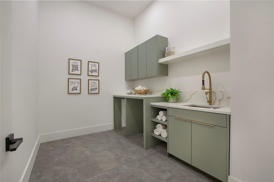 Clothes washing area featuring sink