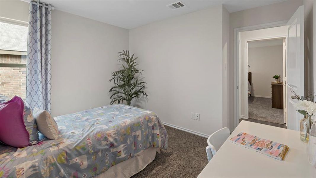 Bedroom featuring dark carpet and baseboards