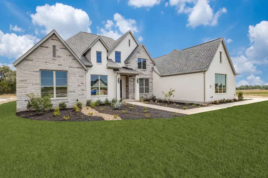Front exterior of a new home in Hilltop Ranch, Leander, TX, highlighting curb appeal (Image 2). Front exterior of a new home in Hilltop Ranch, Leander, TX, highlighting curb appeal (Image 2).