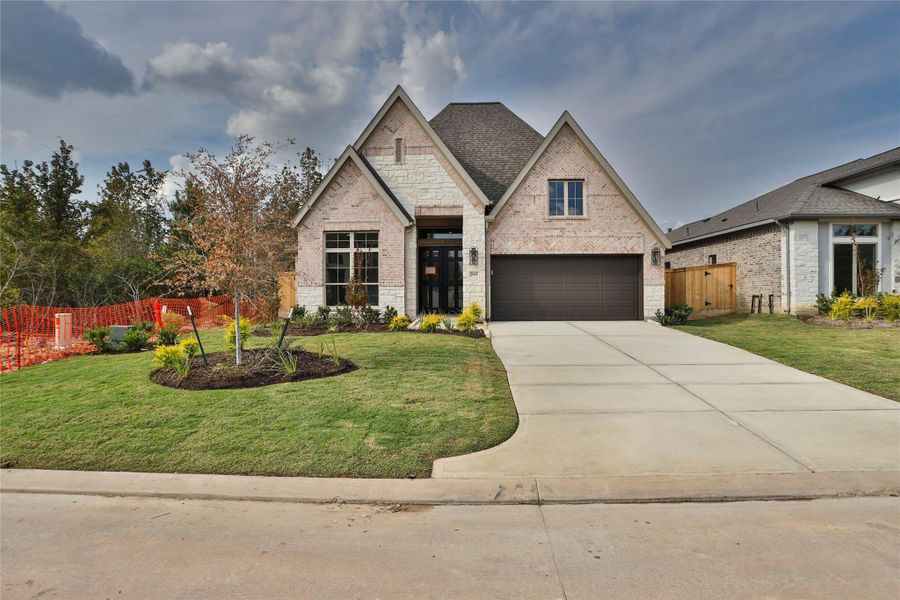 Front exterior of a new home in Kresston 50', Magnolia, TX, highlighting curb appeal (Image 1). Front exterior of a new home in Kresston 50', Magnolia, TX, highlighting curb appeal (Image 1).
