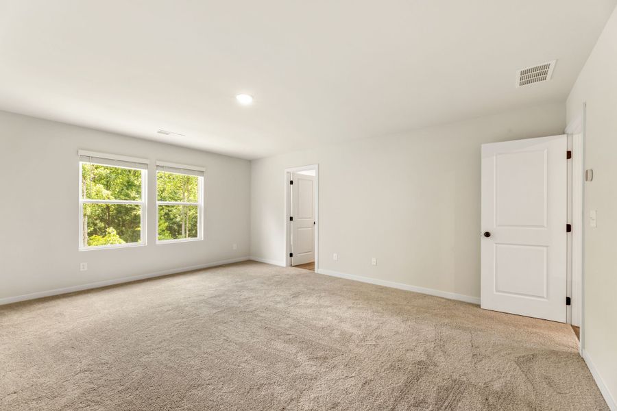 A room with a carpet and a door. A room with a carpet and a door.