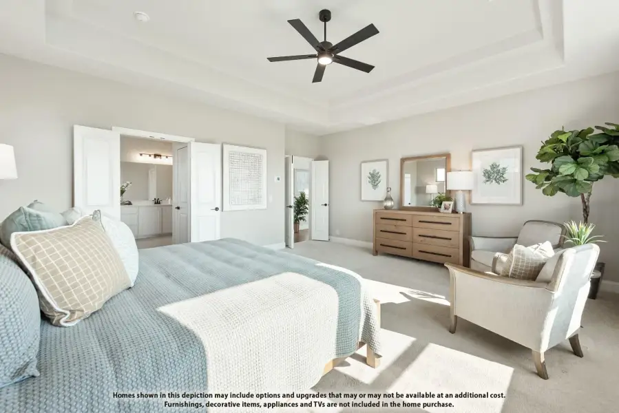 Master bedroom with tray ceiling, ceiling fan, carpet flooring, and open door to ensuite bathroom Master bedroom with tray ceiling, ceiling fan, carpet flooring, and open door to ensuite bathroom