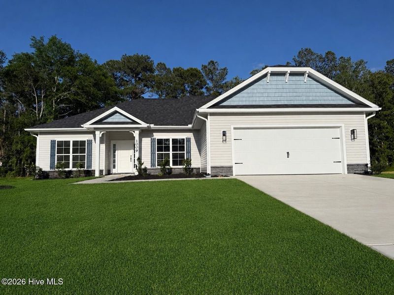 Front exterior of a new home in Wood Creek Landing, Leland, NC, highlighting curb appeal (Image 1). Front exterior of a new home in Wood Creek Landing, Leland, NC, highlighting curb appeal (Image 1).