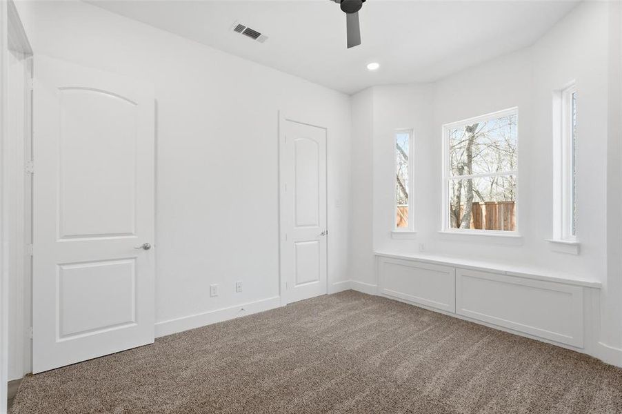 Rear secondary bedroom with seating/storage under window