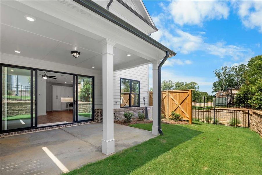 Exterior details and patio area of a home in Millcroft Townhomes, Buford (Image 4).