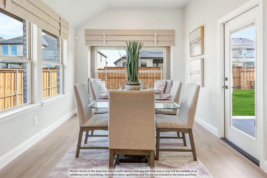 Bright dining room with glass table, six upholstered chairs, hardwood floors, and large windows overlooking backyard Bright dining room with glass table, six upholstered chairs, hardwood floors, and large windows overlooking backyard
