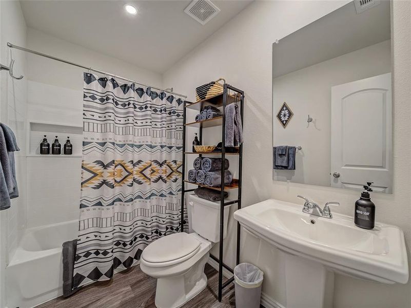 2nd Full Bathroom featuring shower / bath combo and dark wood finished floors