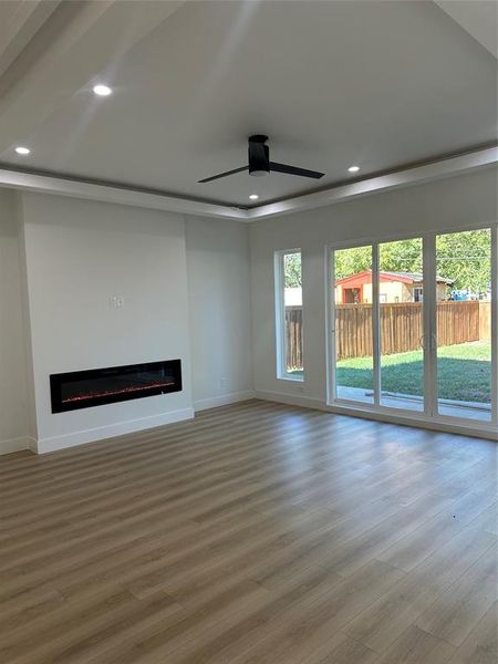 Unfurnished living room with hardwood / wood-style flooring and ceiling fan