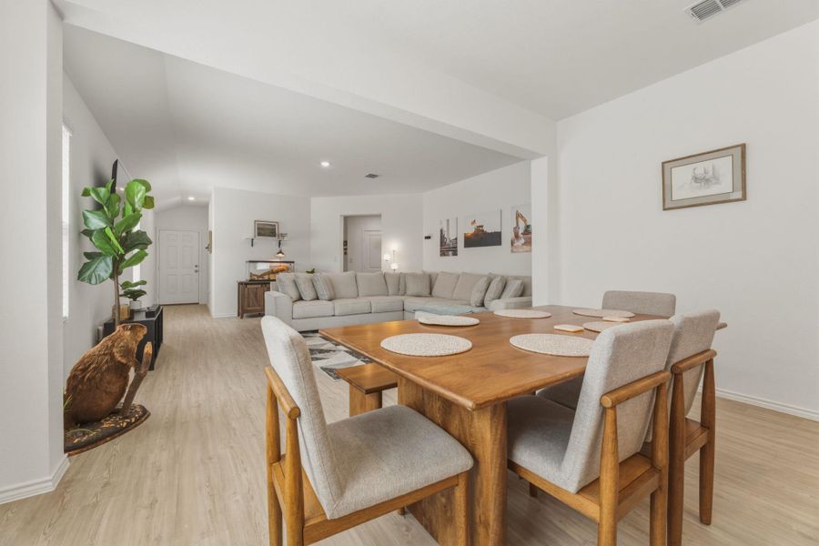 The property features an open-concept living area with light-toned flooring throughout