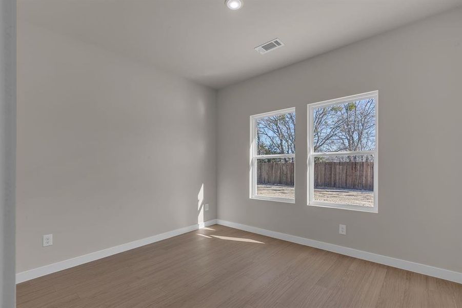 Empty room featuring hardwood / wood-style floors