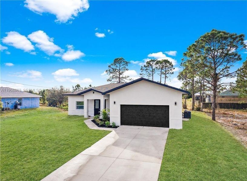 Front exterior of a new home in , Lehigh Acres, FL, highlighting curb appeal (Image 2). Front exterior of a new home in , Lehigh Acres, FL, highlighting curb appeal (Image 2).