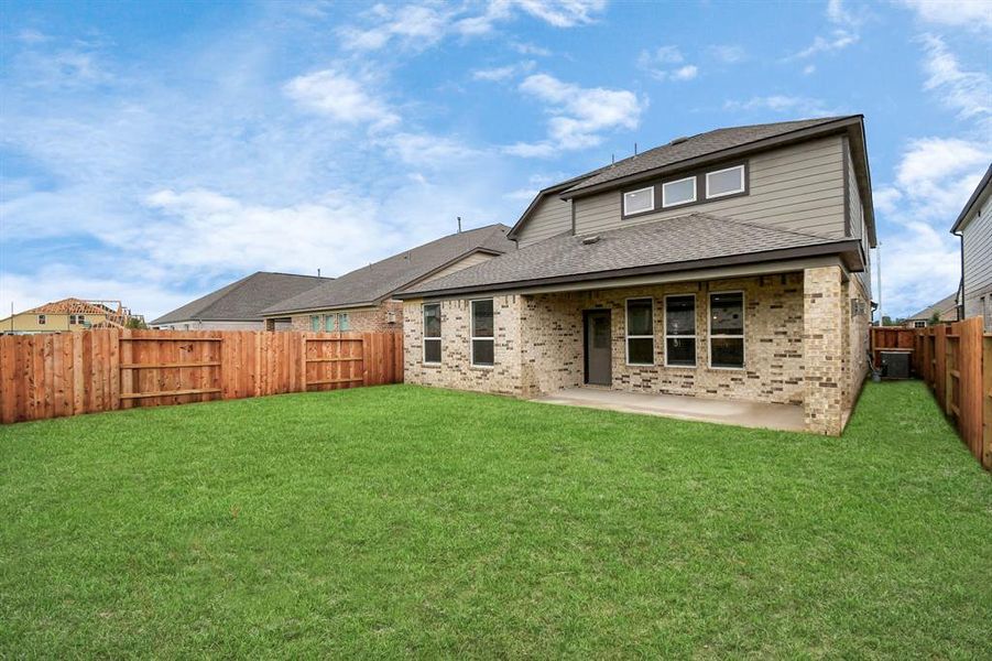 Explore the expansive backyard with its inviting covered patio—a perfect blend of space for the kids to play and adults to unwind.