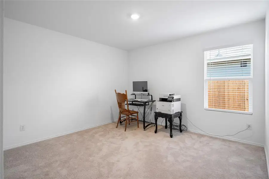 Room may be used as office featuring a single window with blinds, white walls, and a ceiling light fixture Room may be used as office featuring a single window with blinds, white walls, and a ceiling light fixture