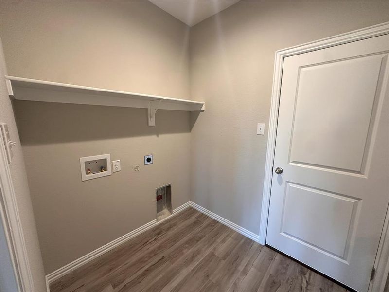 Washroom featuring hookup for a gas dryer, washer hookup, electric dryer hookup, and dark hardwood / wood-style floors