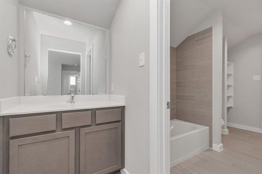 Other side of the jack and jill bath. Sample photo of completed home with similar floor plan. As-built interior colors and selections may vary.