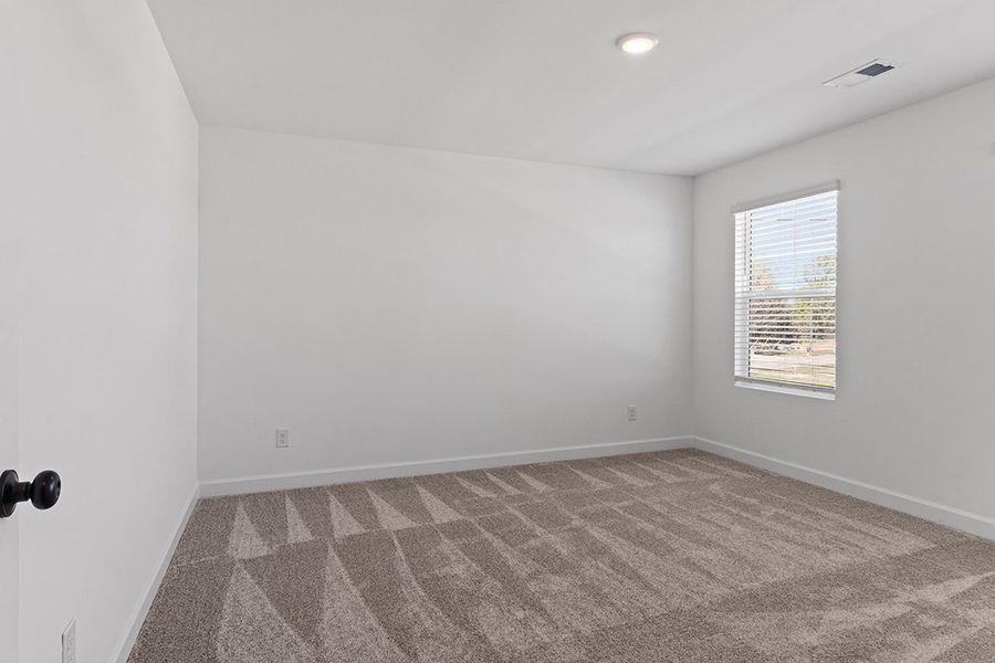 A room with a carpet and a window. A room with a carpet and a window.