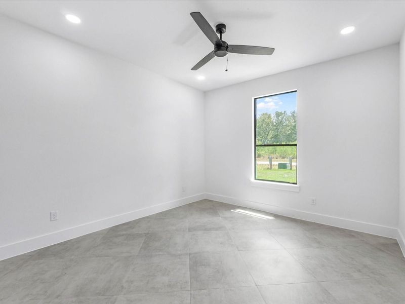 second bedroom faces the front lawn with a fan for added comfort.