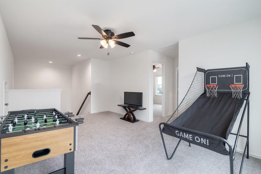 The upstairs game room is a bright and inviting space, featuring multiple windows with privacy blinds that let in natural light and a ceiling fan for added comfort—perfect for relaxation or entertainment. The upstairs game room is a bright and inviting space, featuring multiple windows with privacy blinds that let in natural light and a ceiling fan for added comfort—perfect for relaxation or entertainment.
