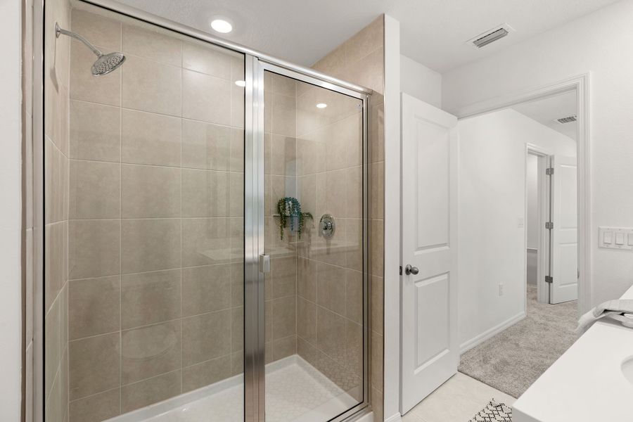 Shower Enclosure and Floor to Ceiling Tile in Primary Bath