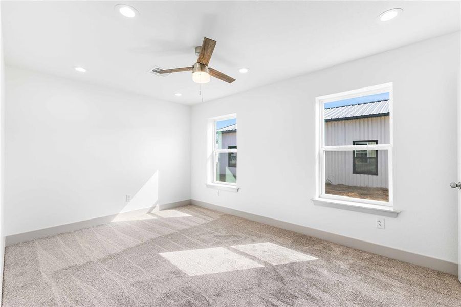 Carpeted spare room featuring recessed lighting, a ceiling fan, and baseboards Carpeted spare room featuring recessed lighting, a ceiling fan, and baseboards