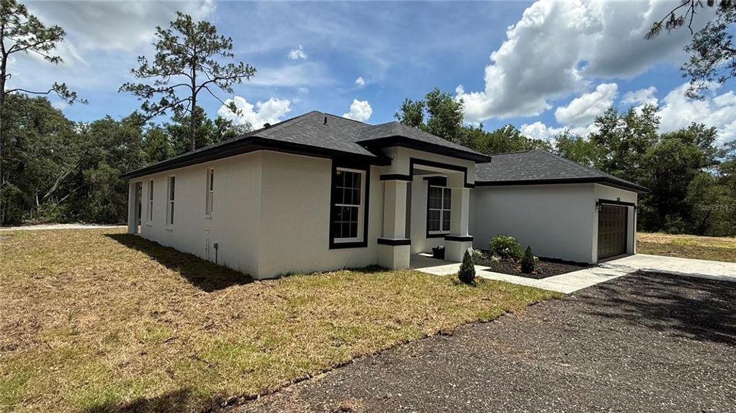 Front exterior of a new home in , Webster, FL, highlighting curb appeal (Image 6).