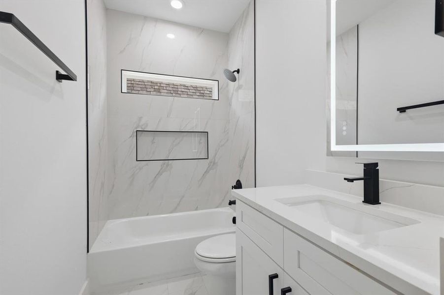 Full bathroom with vanity, shower / bath combination, light marble finish floors, and recessed lighting Full bathroom with vanity, shower / bath combination, light marble finish floors, and recessed lighting