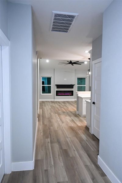 Corridor with light wood-style floors and recessed lighting