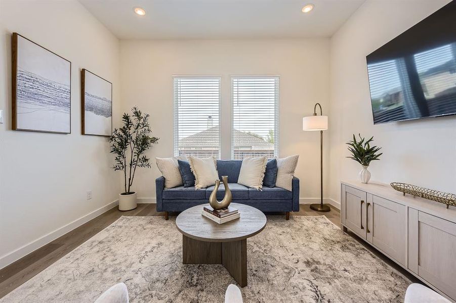 Living area featuring wood finished floors and recessed lighting