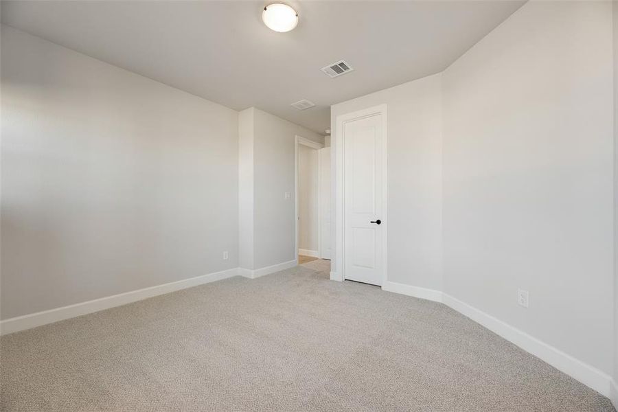 Spare room featuring baseboards and light colored carpet Spare room featuring baseboards and light colored carpet