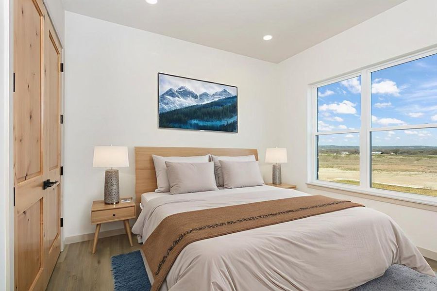 Bedroom featuring wood finished floors and recessed lighting Bedroom featuring wood finished floors and recessed lighting