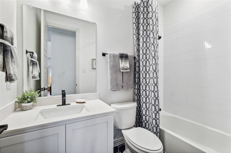 Full bathroom with vanity, toilet, and shower / bath combo