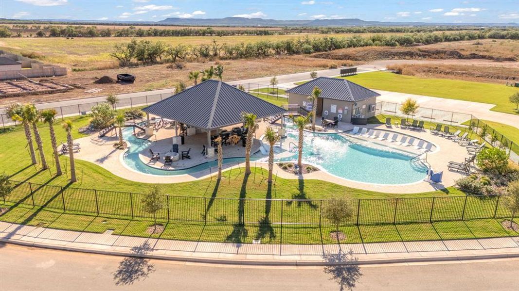 Aerial view of sparsely populated area with a pool