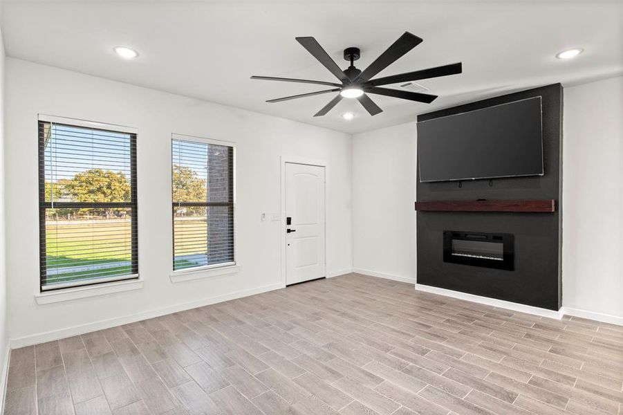 Unfurnished living room featuring recessed lighting, light wood-style floors, and ceiling fan