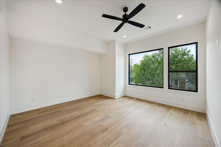 Bedroom #3 – offers an en-suite bath and walk-in closet. Features a ceiling fan, recessed lighting, and wood flooring. Bedroom #3 – offers an en-suite bath and walk-in closet. Features a ceiling fan, recessed lighting, and wood flooring.