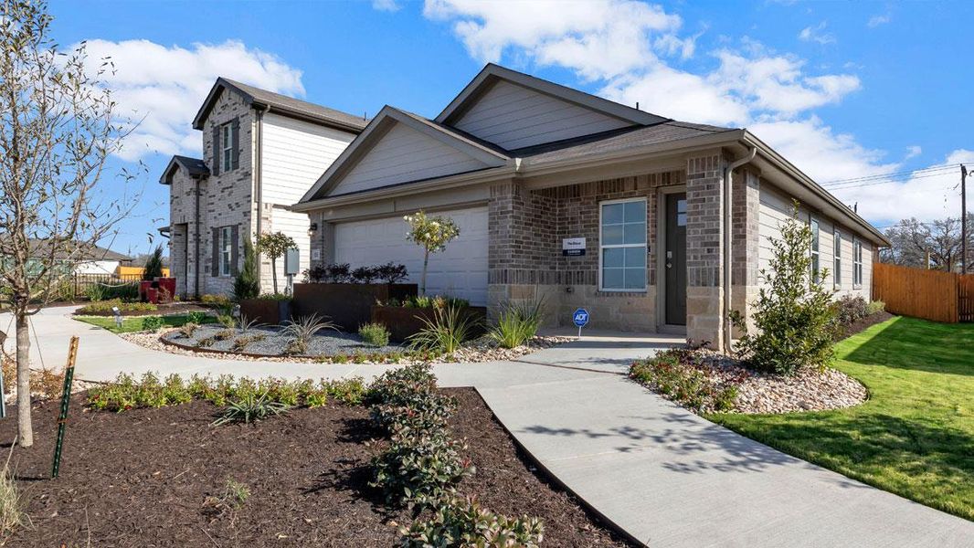 Front exterior of a new home in Prairie Lakes, Buda, TX, highlighting curb appeal (Image 21).