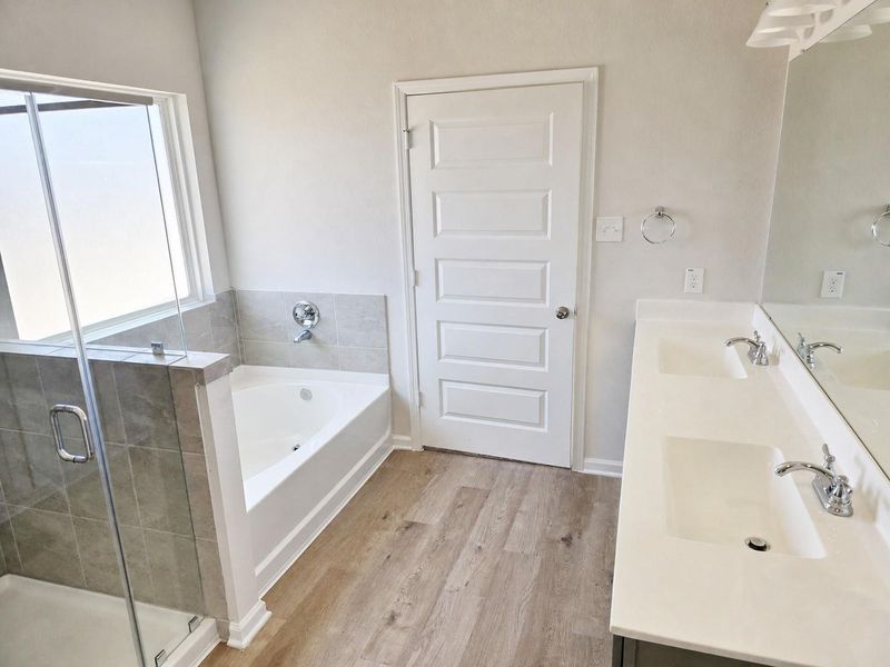 The Shetland III- Primary Suite with Separate Garden Tub and Shower. Home under construction, photo used for illustrative purposes only, colors and options will vary.
