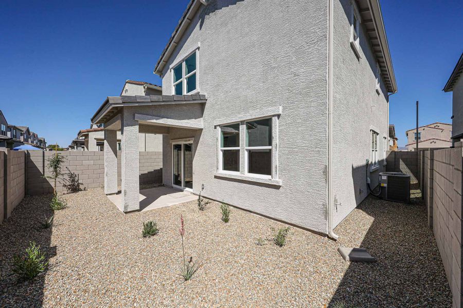 A white house with a stone patio. A white house with a stone patio.