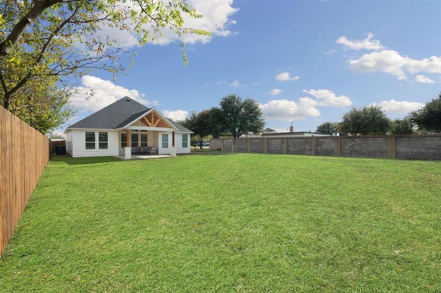 Fenced backyard featuring a patio Fenced backyard featuring a patio