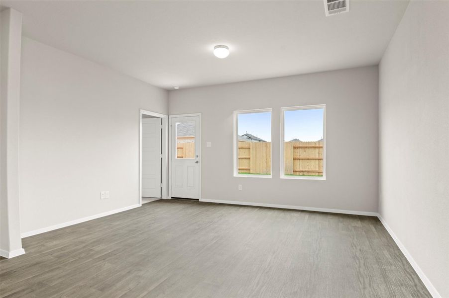 Empty room featuring baseboards and light wood-type flooring