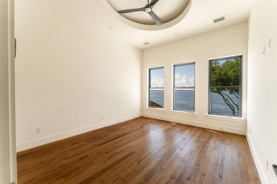 Unfurnished room with wood finished floors and ceiling fan