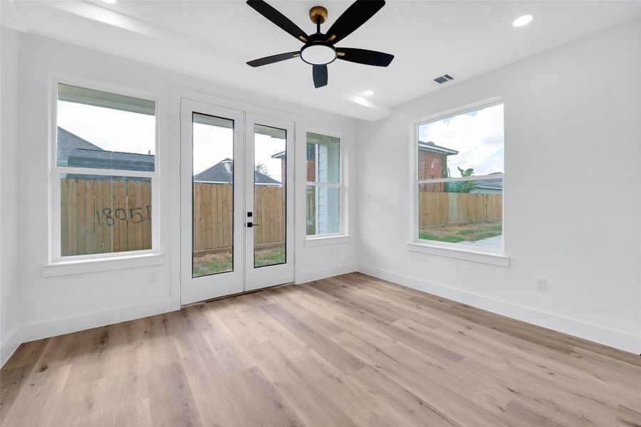 The french doors lead to the backyard, green space, and a covered porch to enjoy Houston's cool fall evenings and sunny winter days. Landscaping to come.