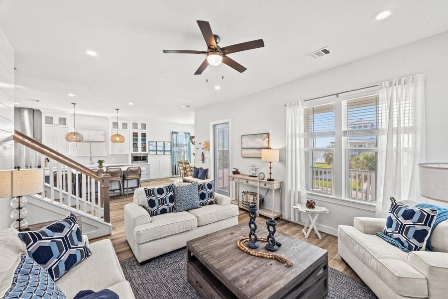 The open-concept living area is highlighted by expansive windows that perfectly frame breathtaking views of Galveston Bay.