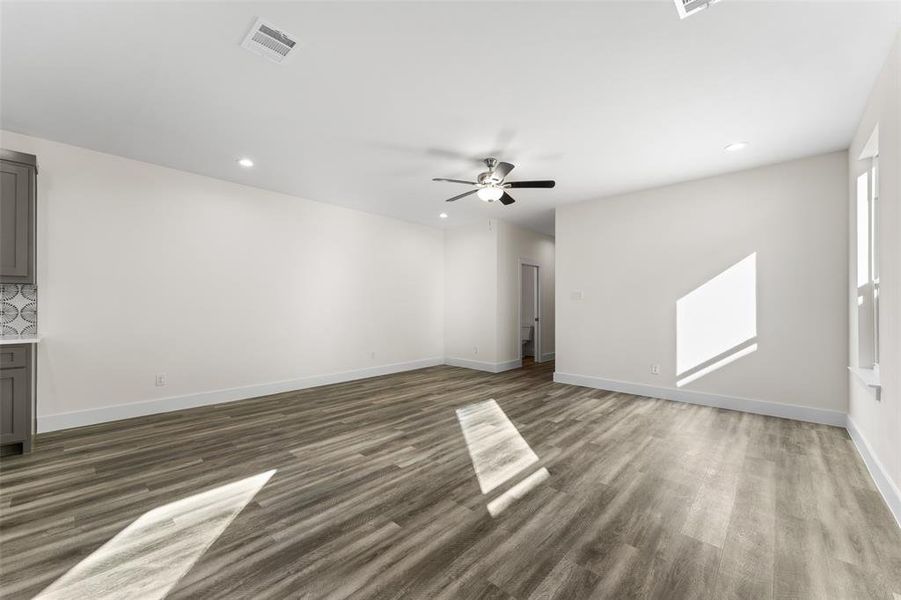 Unfurnished living room with recessed lighting, dark wood-style flooring, and ceiling fan Unfurnished living room with recessed lighting, dark wood-style flooring, and ceiling fan