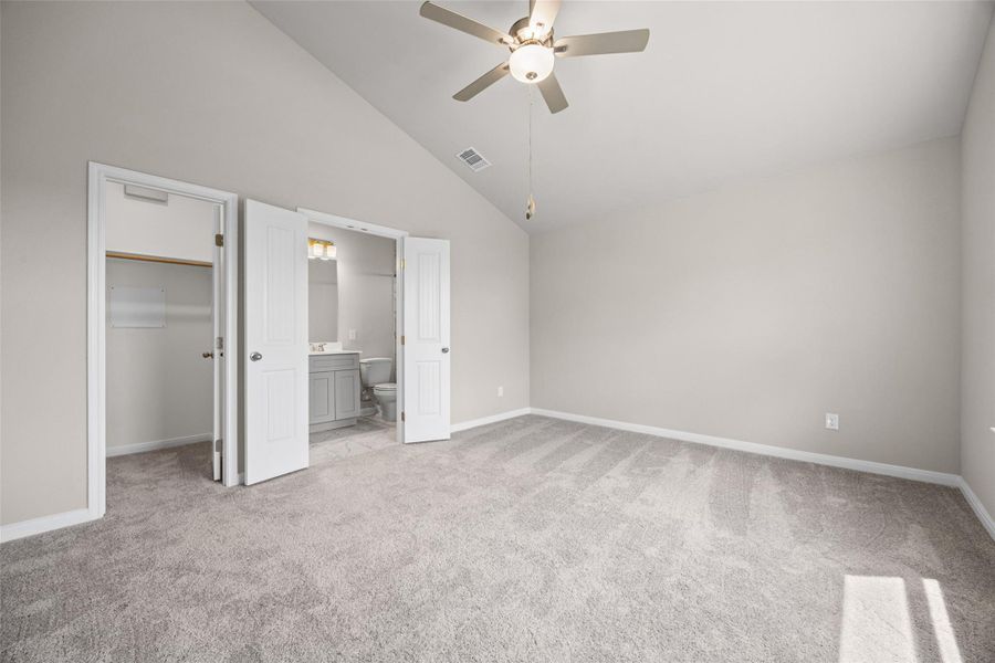 High vaulted ceilings rise above plush carpeting in this serene master bedroom retreat. High vaulted ceilings rise above plush carpeting in this serene master bedroom retreat.