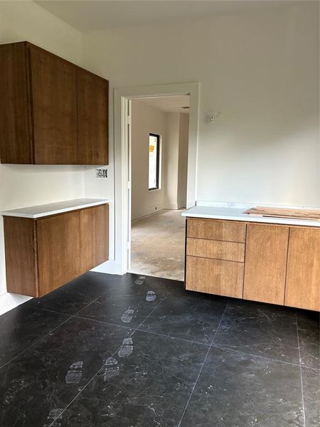 Part of the master bath.  Countertops are honed Quartzite.  Another set on the other side of cabinets.  Free standing Tub under window overlooking pool.