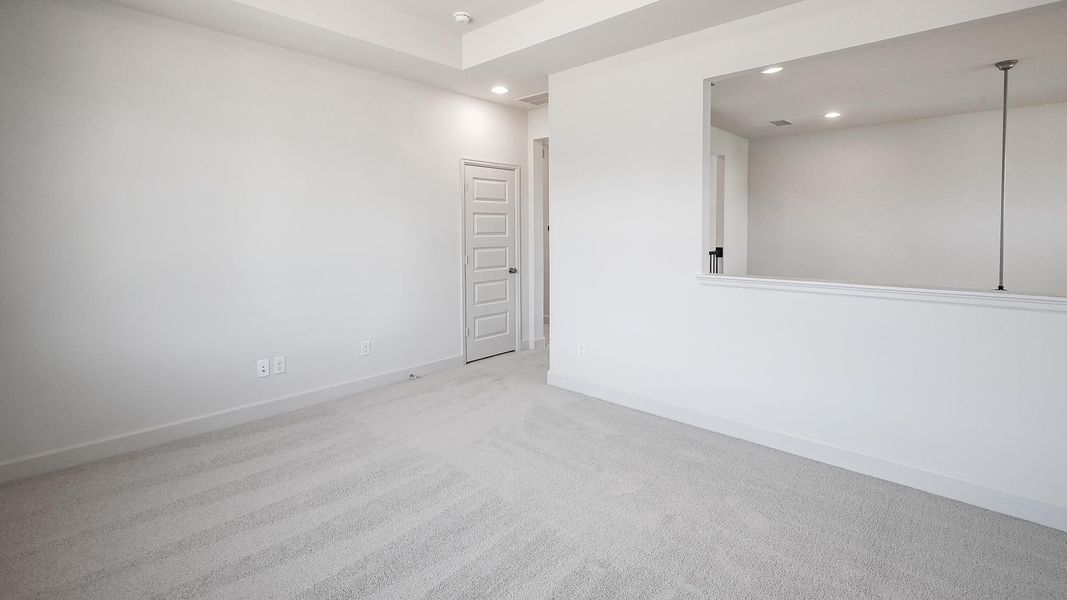 Carpeted empty room with baseboards and recessed lighting Carpeted empty room with baseboards and recessed lighting