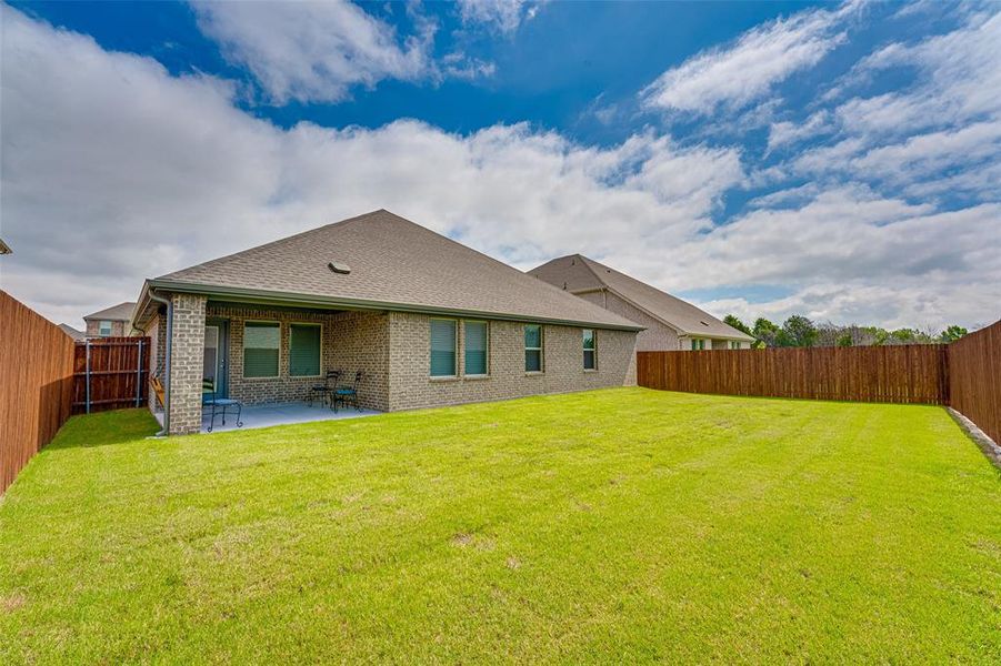 Exterior details and patio area of a home in Fireside by the Lake, Garland (Image 20).
